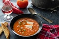 Tomato soup with white cheese in black bowl Royalty Free Stock Photo