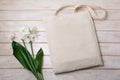 Rustic tote bag mockup with white lily
