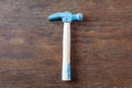 Rustic toy carpenter hammer on wooden table. Royalty Free Stock Photo