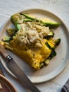 Rustic traditional breakfast egg omelette and avocado, spinach