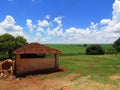 Rustic traditional shed at the farm. There are soy plantation in the scenery and the sky is bright blue Royalty Free Stock Photo