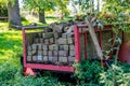 Rustic trailer car with bricks and two logs Royalty Free Stock Photo