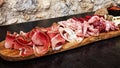 Rustic Tuscan tray with typical products: prosciutto ham, brawn, finocchiona, crostini, salami, tuscan chilli and sliced pecorino Royalty Free Stock Photo