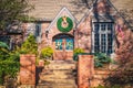 Rustic upscale brick residential home with magnolia flower wreath on double doors and large Christmas wreath above - flying Royalty Free Stock Photo