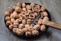 Whole and cracked   walnuts and a hammer Royalty Free Stock Photo