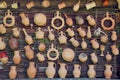 Rustic clay jugs, pots and mugs hanging on wicker wall Royalty Free Stock Photo