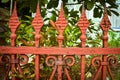 Ornate antique Victorian orange color iron garden fence Royalty Free Stock Photo