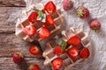 rustic waffles with strawberries, powdered sugar and mint closeup. horizontal top view Royalty Free Stock Photo