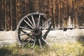 Rustic wagon wheel against an old log cabin. Taken in Bannack Ghost Town, Montana Royalty Free Stock Photo