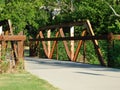 Rustic walk through bridge wwith green trees