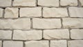 A rustic wall features a pattern of light-colored, irregularly shaped stone bricks with visible mortar lines Royalty Free Stock Photo