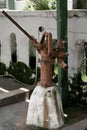 Rustic weathered cast iron hand water pump with textured surface standing on concrete in the park. Royalty Free Stock Photo