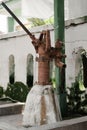 Rustic weathered cast iron hand water pump with textured surface standing on concrete in the park. Royalty Free Stock Photo