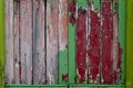 A rustic weathered wood panel door with the paint peeling off leaving layers of different colours Royalty Free Stock Photo