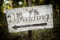 Rustic wedding arrow sign on a shovel.