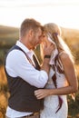 Young hippie boho couple in love outdoors. Portrait of young stylish fashion couple posing in summer in field, hugging Royalty Free Stock Photo