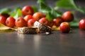 Rustic wedding decorations. Red small apples and gold rings on a wooden background with a blurry foreground with a place for an Royalty Free Stock Photo