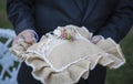 Rustic wedding ring pillow in male hands, beautiful wedding accessories Royalty Free Stock Photo