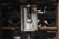 Rustic white painted can on white hanging on wall outdoors.Aged rusty iron little bell .Concept decor element in interior of deck, Royalty Free Stock Photo