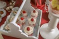 Rustic white wooden tray with small size glass pastry desserts and cupcakes Royalty Free Stock Photo