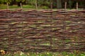 rustic wicker fence made of willow twigs Royalty Free Stock Photo