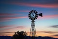 Rustic Windmill Silhouette Against a Twilight Sky, Vanes Motion Blurred as They Capture the Fading Light