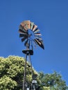 Rustic Windmill: Weathered Vane Against a Clear Blue Sky Royalty Free Stock Photo