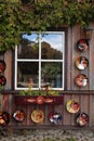 Rustic window with ceramic plates and flower pot in wood rural h