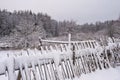 Rustic winter landscape with a fallen wooden fence covered in snow Royalty Free Stock Photo