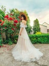 Rustic woman bride in white long wedding dress, train. Brunette girl straw wide brim hat. Summer landscape modern rural Royalty Free Stock Photo