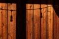 Rustic wood background with shadows of deck post with string of lights Royalty Free Stock Photo