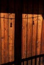 Rustic wood background with shadows of deck railing and post with string of lights Royalty Free Stock Photo