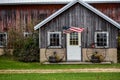 Rustic wood barn with American flag blowing in the wind Royalty Free Stock Photo