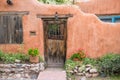 Rustic wood door set in old adobe wall in Santa Fe, New Mexico Royalty Free Stock Photo