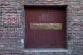 Rustic wood door surrounded by aging brick wall. Royalty Free Stock Photo