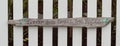 rustic wood sign says (stop and smell roses) in rustic wooden white fence background