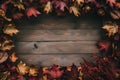 Rustic wooden backdrop framed with autumn leaves and reddish brown objects Royalty Free Stock Photo
