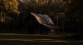 Rustic Wooden Barn in Autumn Woods at Sunset Royalty Free Stock Photo