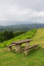 Rustic wooden bench, table and beautiful nature of slovenian countryside with vineyard