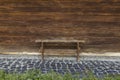 Rustic wooden bench and wall outside of rural yard background and stone paved floor Royalty Free Stock Photo