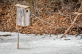 Rustic Wooden Birdhouse in Frozen Pond Royalty Free Stock Photo