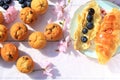 Rustic wooden breakfast background with bluberries, fresh muffins and blooming cherry flowers Royalty Free Stock Photo