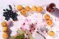 Rustic wooden breakfast background with bluberries, fresh scones and blooming cherry flowers Royalty Free Stock Photo