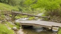 A rustic wooden bridge crossing a small stream in the heart of the village.
