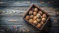 A rustic wooden crate overflowing with a harvest of whole walnuts on a dark wood surface. Generative AI Royalty Free Stock Photo