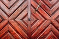 Rustic wooden door detail as background, weathered surface of massive entrance doorway
