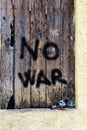 Rustic wooden door with inscription no war. Dove as a symbol of peace