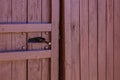 Rustic wooden door with metal latch in close-up view Royalty Free Stock Photo