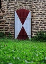 Rustic wooden door with red and white pattern. Royalty Free Stock Photo
