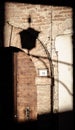 Rustic Wooden Door with Shadow of a Lamp on a Brick Wall Royalty Free Stock Photo